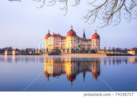 Moritzburg castle after sunrise at winter time, Germany 74198727