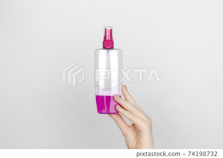 A woman is holding hair spray. Place for your text. The concept of hazardous substances in cosmetics and household chemicals 74198732