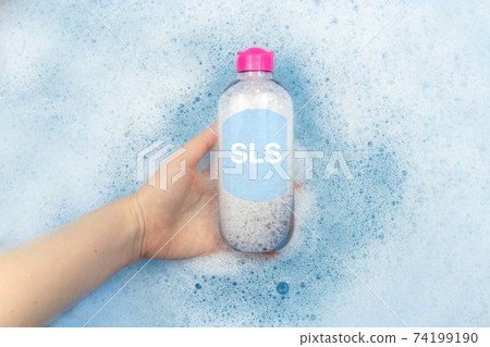 A bottle of micellar water floating in soapy water. Harmful composition of ingredients. Cleanser with SLS. The concept of hazardous substances in cosmetics and household chemicals A bottle of micellar water floating in soapy water. Harmful composition of ingredients. Cleanser with SLS. The concept of hazardous substances in cosmetics and household chemicals 74199190