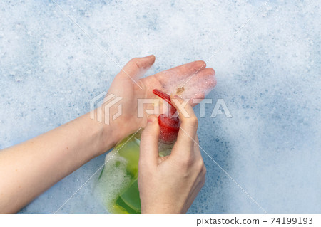 Bottles of detergents float in the foam. The concept of the dangers of household chemicals. Sodium laureate, parabens, sulfates and other chemical compounds in the foam. Liquid soap in a yellow jar Bottles of detergents float in the foam. The concept of the dangers of household chemicals. Sodium laureate, parabens, sulfates and other chemical compounds in the foam. Liquid soap in a yellow jar 74199193