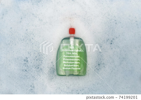 A bottle of Liquid soap floating in soapy water. Harmful composition of ingredients, detergent with SLS, Propylene Glycol, TEA, DEA, Formaldehyde, Propylparaben, Methylparaben, Butylparaben, Sodium 74199201
