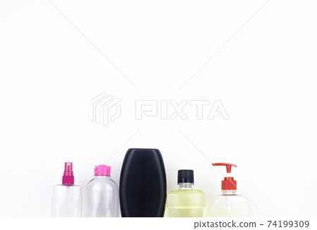 Isolated bottles of detergents on a white background. The hand takes the jars of detergents. In the photo, shampoo, micellar water, liquid soap and mouthwash. Household chemicals in colored containers Isolated bottles of detergents on a white background. The hand takes the jars of detergents. In the photo, shampoo, micellar water, liquid soap and mouthwash. Household chemicals in colored containers 74199309