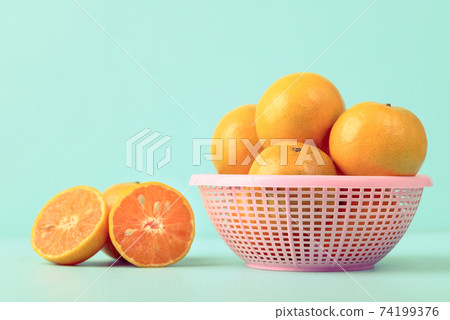 Fresh tangerine orange fruit in a basket Fresh tangerine orange fruit in a basket 74199376