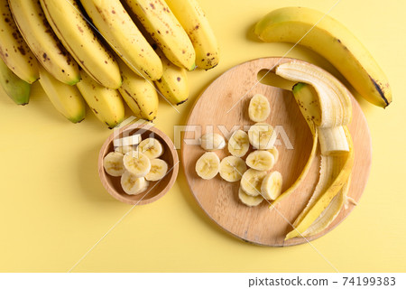 Sliced ripe banana fruit on wooden cutting board 74199383