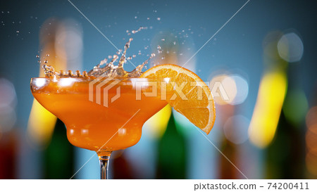Closeup of splashing orange cocktail Closeup of splashing orange cocktail 74200411