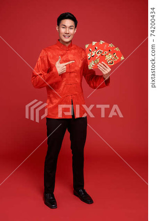 Happy Chinese new year. Asian man holding angpao or red packet monetary gift  74200434