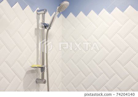 Modern shower on wall rail in modern white bathroom Modern shower on wall rail in modern white bathroom 74204140