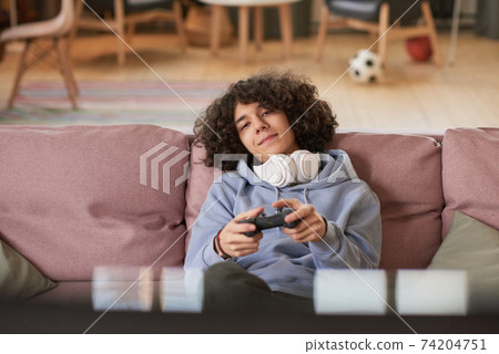 Teenager playing game Teenager playing game 74204751