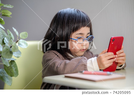 學習的女孩，當看智能手機時 74205095