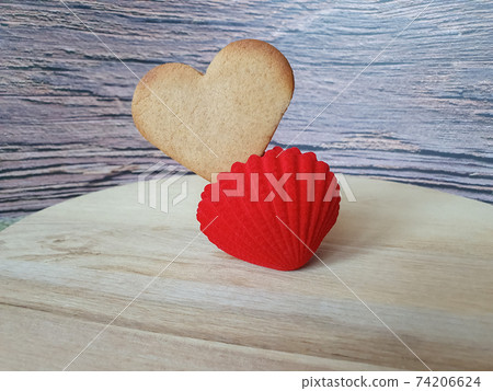 heart-shaped homemade gingerbread placed in a red jewelry box on a light wooden background. Valentine's Day, greeting card, pastry, Copy space, top view, love concept, Engagement, love, marriage 74206624
