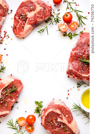 cooking Ribeye steak with spices, cherry tomatoes and olive oil 74206750