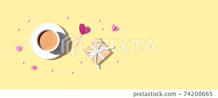 A cup of coffee with a gift box and hearts A cup of coffee with a gift box and hearts 74208665