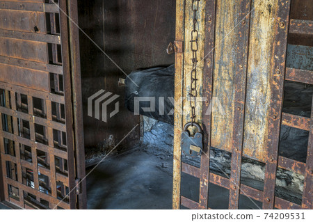 vintage jail cell with rusty bars 74209531