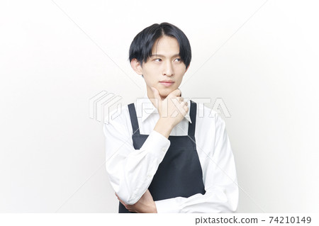 Male restaurant clerk think Male restaurant clerk think 74210149