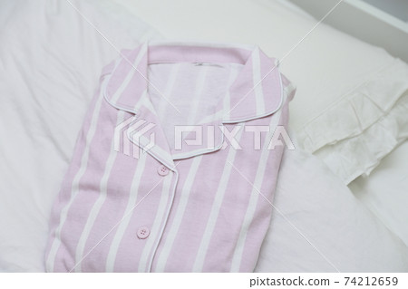 Pajamas placed on the bed in the bedroom 74212659
