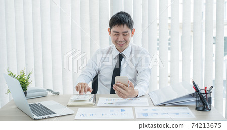 The businessman hand sits at their desks and calculates financial graphs showing the results of their investments planning the process of successful business growth The businessman hand sits at their desks and calculates financial graphs showing the results of their investments planning the process of successful business growth 74213675