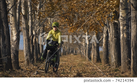 The woman travel on mixed terrain cycle touring with bikepacking. The traveler journey with bicycle bags. Sport tourism bikepacking. The woman travel on mixed terrain cycle touring with bikepacking. The traveler journey with bicycle bags. Sport tourism bikepacking. 74214394