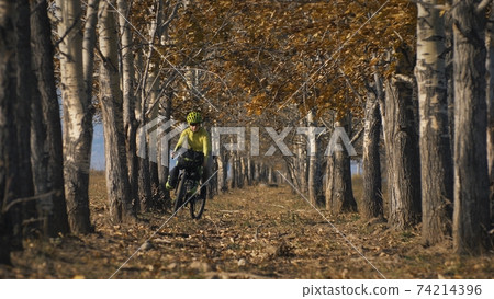 The woman travel on mixed terrain cycle touring with bikepacking. The traveler journey with bicycle bags. Sport tourism bikepacking. The woman travel on mixed terrain cycle touring with bikepacking. The traveler journey with bicycle bags. Sport tourism bikepacking. 74214396