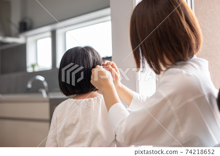 Mother hair child where mother sets daughter's hair in the house Mother hair child where mother sets daughter's hair in the house 74218652