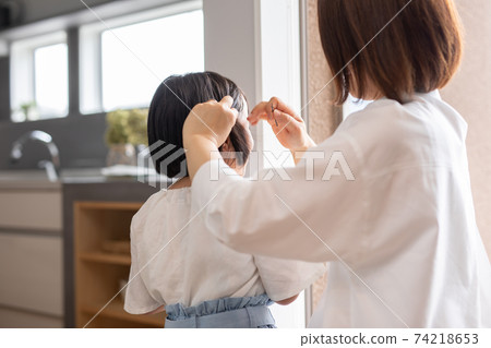 Mother hair child where mother sets daughter's hair in the house Mother hair child where mother sets daughter's hair in the house 74218653