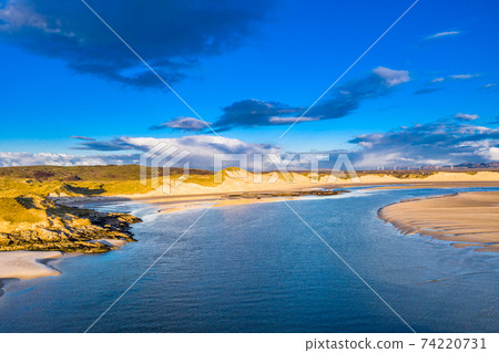 The coast between Kiltoorish bay beach and the Sheskinmore bay between Ardara and Portnoo in Donegal - Ireland The coast between Kiltoorish bay beach and the Sheskinmore bay between Ardara and Portnoo in Donegal - Ireland 74220731