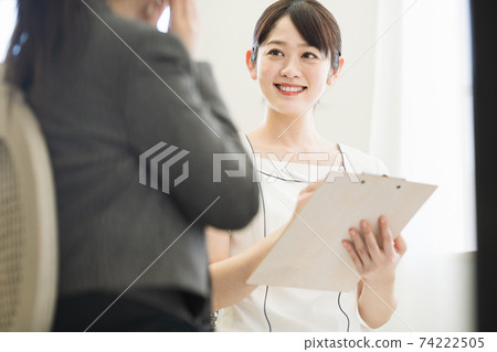 Female staff at an esthetic salon providing beauty counseling 74222505