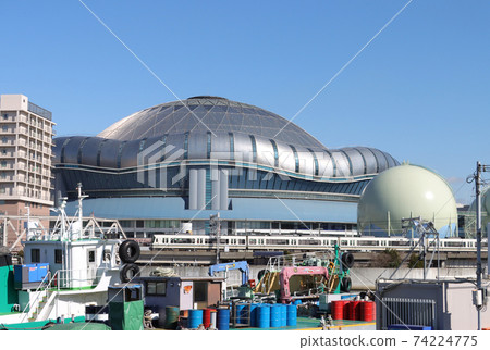 Series 221 of the Osaka Loop Line running with the Dome Stadium in the background 74224775
