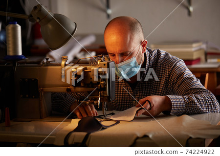 man working with sewing machine man working with sewing machine 74224922