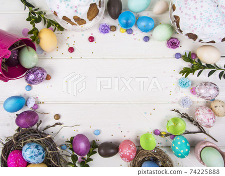 Colorful background with Easter eggs on white wooden board background. Happy Easter concept. Can be used as poster, background, holiday card Colorful background with Easter eggs on white wooden board background. Happy Easter concept. Can be used as poster, background, holiday card 74225888