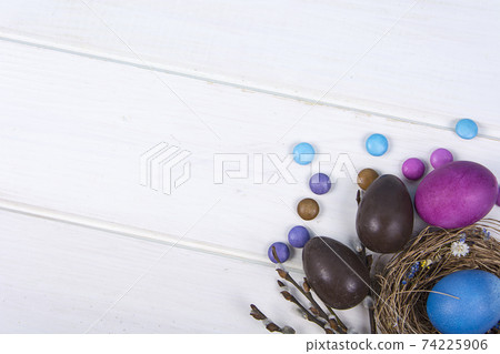 Colorful background with Easter eggs on white wooden board background. Happy Easter concept. Can be used as poster, background, holiday card. 74225906