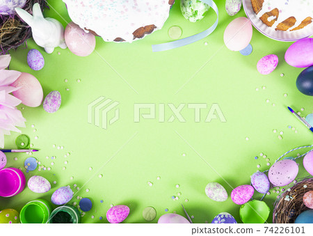 Colorful background with Easter eggs on green background. Happy Easter concept. Can be used as poster, background, holiday card. Flat lay, top view, copy space. Studio Photo 74226101