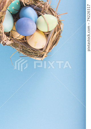 Colorful background with Easter eggs on blue background. Happy Easter concept. Can be used as poster, background, holiday card. Colorful background with Easter eggs on blue background. Happy Easter concept. Can be used as poster, background, holiday card. 74226317