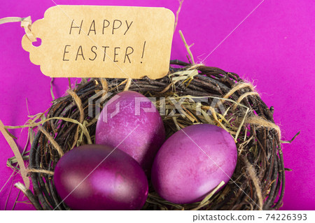 Colorful background with Easter eggs on pink background. Happy Easter concept. Can be used as poster, background, holiday card. Flat lay, top view, copy space. Studio Photo 74226393