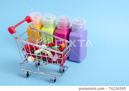 Buy medicine. Shopping basket with various medicinal, pills, tablets on blue background Buy medicine. Shopping basket with various medicinal, pills, tablets on blue background 74226395
