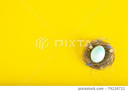 Colorful background with Easter eggs on yellow background. Happy Easter concept. Can be used as poster, background, holiday card. Flat lay, top view, copy space. Studio Photo 74226712