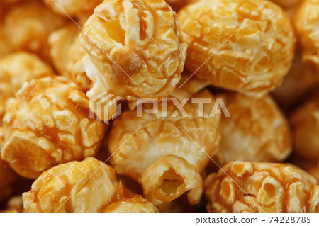 Caramel popcorn macro as a background, full-screen texture. Caramel popcorn macro as a background, full-screen texture. 74228785