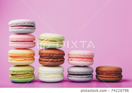 Colorful French macaroni cookies are arranged in a pyramid on the background. 74228796