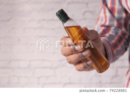 hand holding almond oil with copy space  74228981
