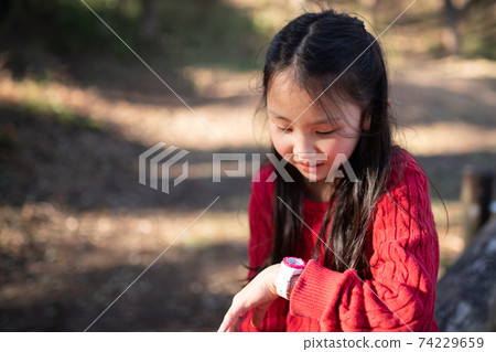 Girl looking at a watch 74229659