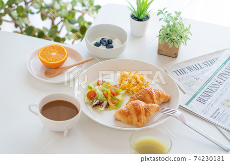 Breakfast croissant, scrambled eggs and salad, yogurt with blueberries, coffee, green juice, orange Breakfast croissant, scrambled eggs and salad, yogurt with blueberries, coffee, green juice, orange 74230181