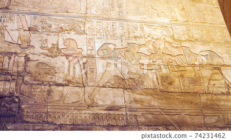 Luxor Egypt Karnak temple sandstone craved hieroglphic wall and column pharoah anceint story Luxor Egypt Karnak temple sandstone craved hieroglphic wall and column pharoah anceint story 74231462