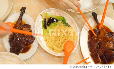 Roasted geese with noodle top view eating Hong Kong food together chopsticks 74231613