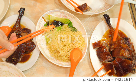 Roasted geese with noodle top view eating Hong Kong food together chopsticks 74231614