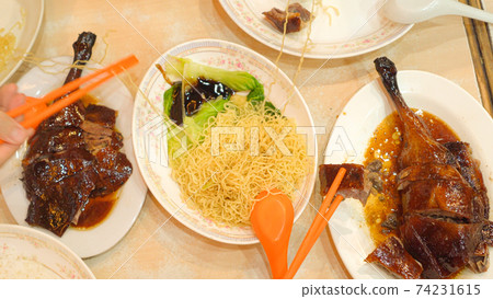 Roasted geese with noodle top view eating Hong Kong food together chopsticks 74231615