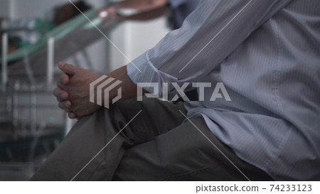 Elder Asian man worry hands while waiting for family at hospital Elder Asian man worry hands while waiting for family at hospital 74233123
