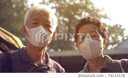 Hopeless Asian Chinese couple aware of 2019 ncv outbreak and smog situation wear preventing mask Hopeless Asian Chinese couple aware of 2019 ncv outbreak and smog situation wear preventing mask 74233126