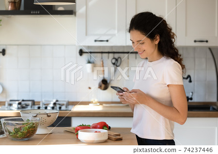 Smiling wife calling husband asking what to make for lunch 74237446