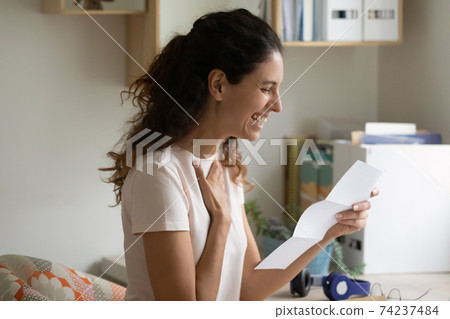 Excited young female applicant receive postal letter inviting on job 74237484
