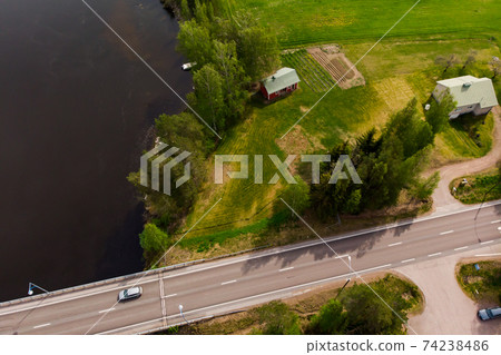 Aerial panoramic view of road and bridge at river Kymijoki, Finland. Aerial panoramic view of road and bridge at river Kymijoki, Finland. 74238486