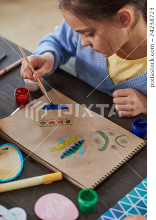 Child painting at the table 74238723